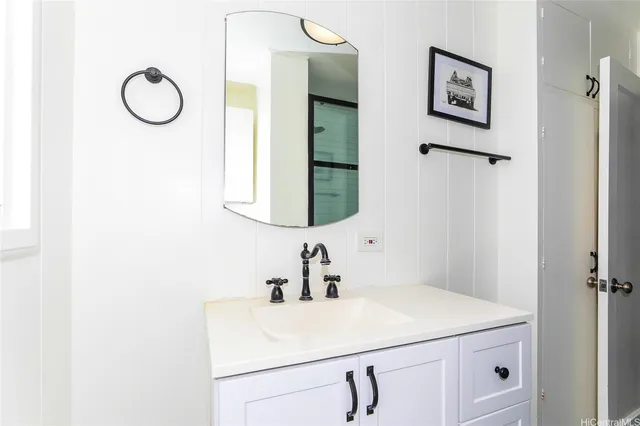 a bathroom with a sink vanity and mirror