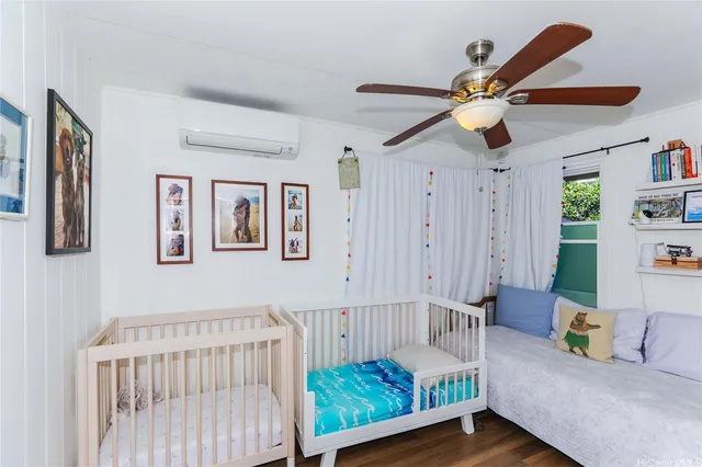a bedroom with furniture and a large window