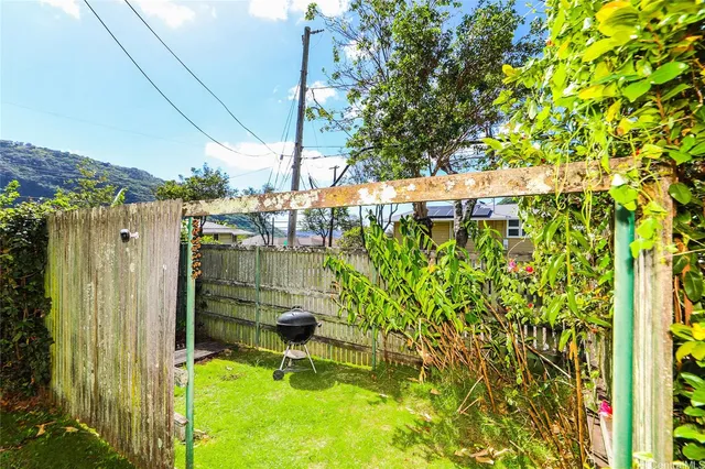 a backyard of a house with lots of green space and outdoor seating