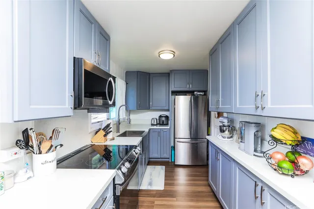 a kitchen with cabinets and stainless steel appliances