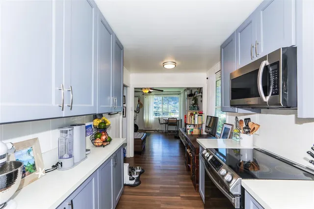 a kitchen with granite countertop a stove and a sink