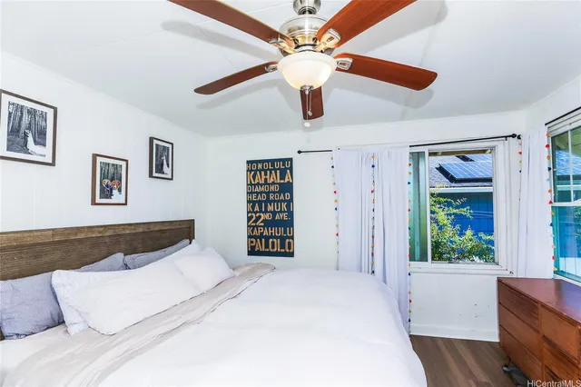 a bedroom with a large bed and a window