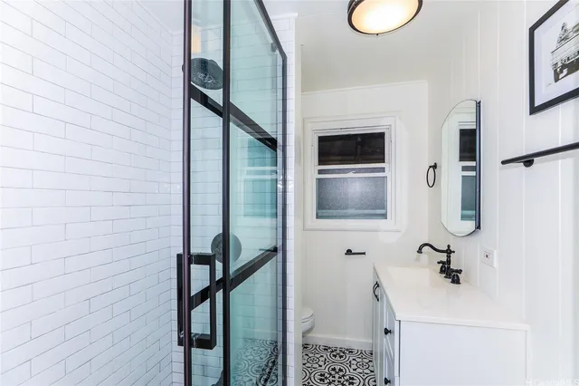 a bathroom with a sink toilet and a mirror