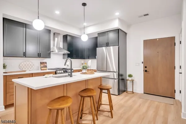 a kitchen with stainless steel appliances a refrigerator and a sink