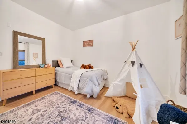 a bed room with a bed and a mirror