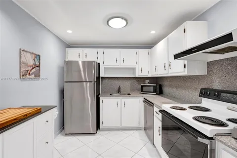 a kitchen with stainless steel appliances granite countertop a refrigerator stove a sink and dishwasher
