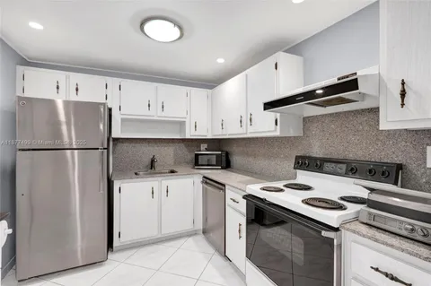 a kitchen with a stove sink and refrigerator
