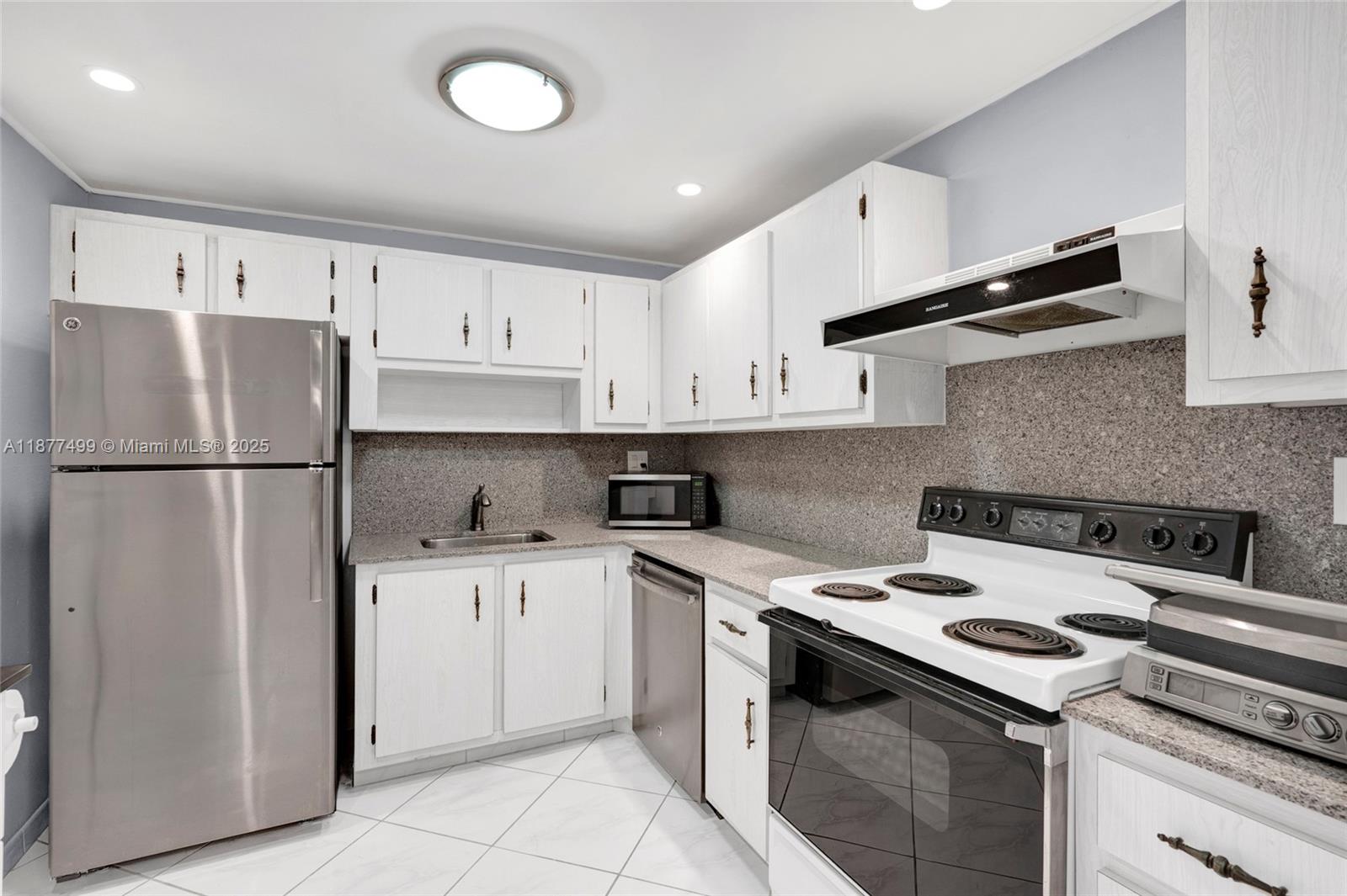 500 Three Islands Boulevard, Unit 320 Hallandale Beach, FL 33009 - Photo 13 of 27 a kitchen with a stove sink and refrigerator