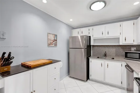a kitchen with stainless steel appliances a refrigerator sink and cabinets