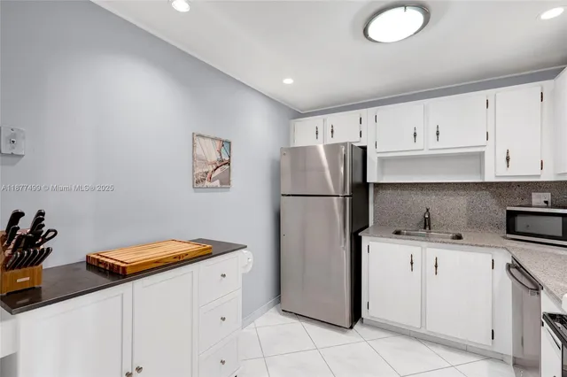 a kitchen with stainless steel appliances a refrigerator sink and cabinets