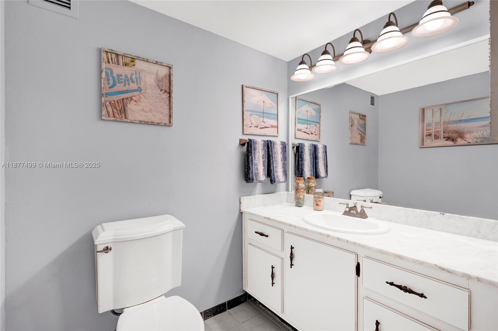 500 Three Islands Boulevard, Unit 320 Hallandale Beach, FL 33009 - Photo 15 of 27 a bathroom with a toilet sink and mirror