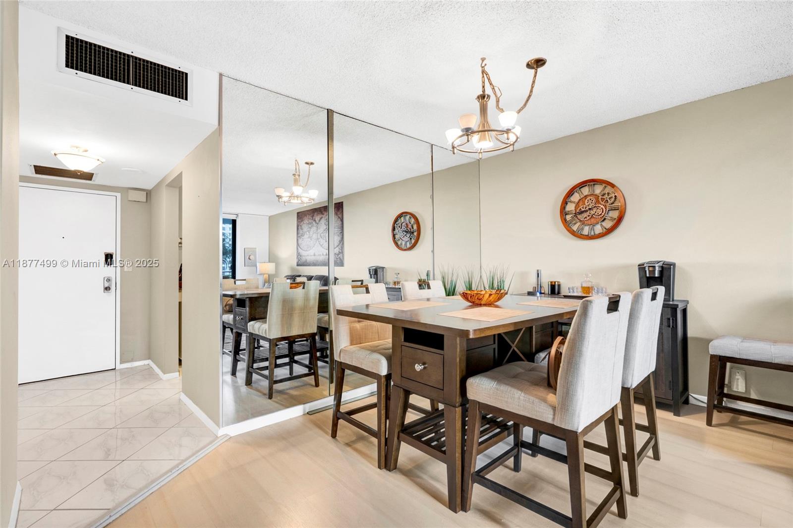 500 Three Islands Boulevard, Unit 320 Hallandale Beach, FL 33009 - Photo 2 of 27 a view of a table and chairs in a kitchen