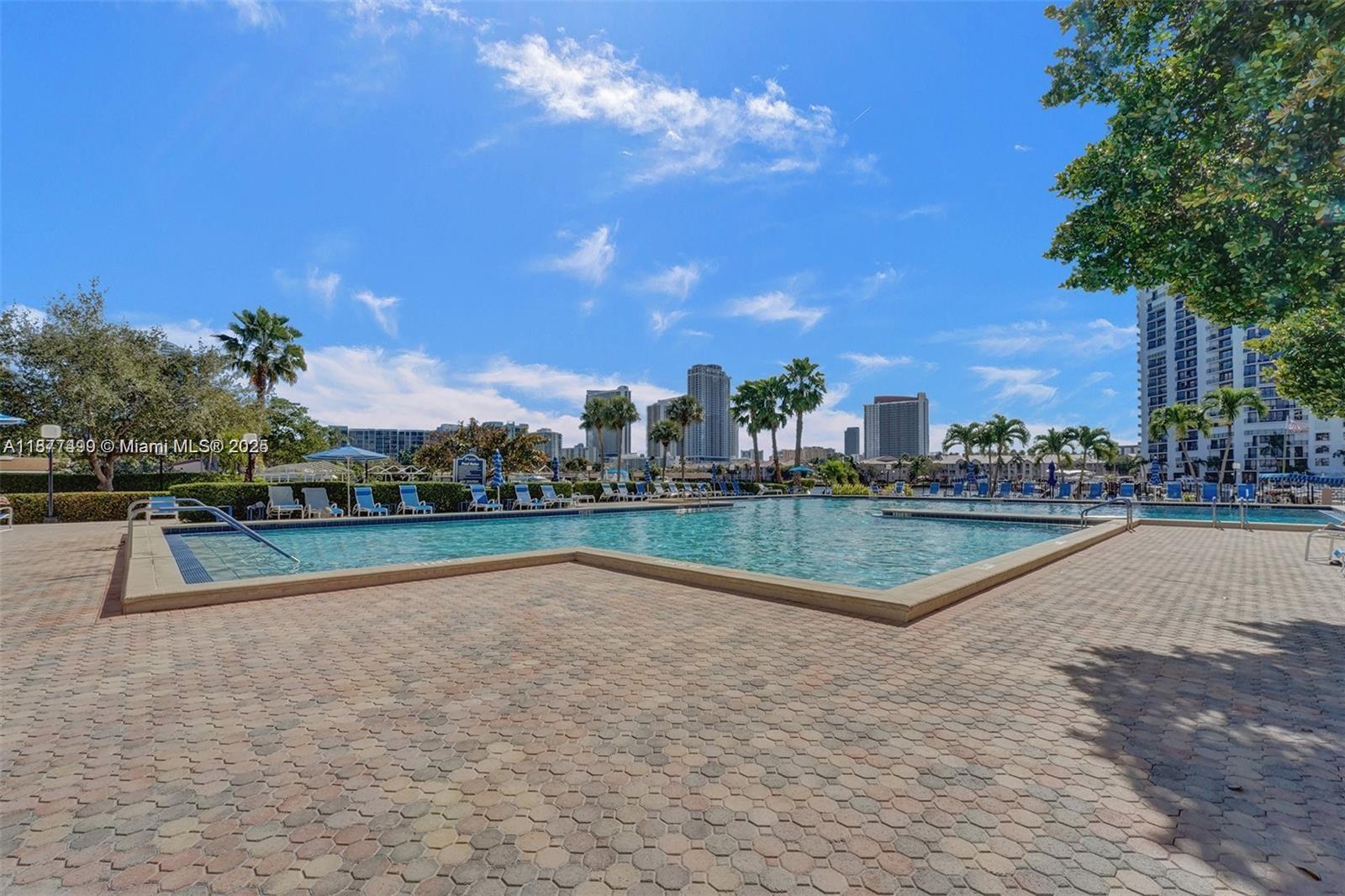 500 Three Islands Boulevard, Unit 320 Hallandale Beach, FL 33009 - Photo 24 of 27 a view of swimming pool with outdoor seating and city view