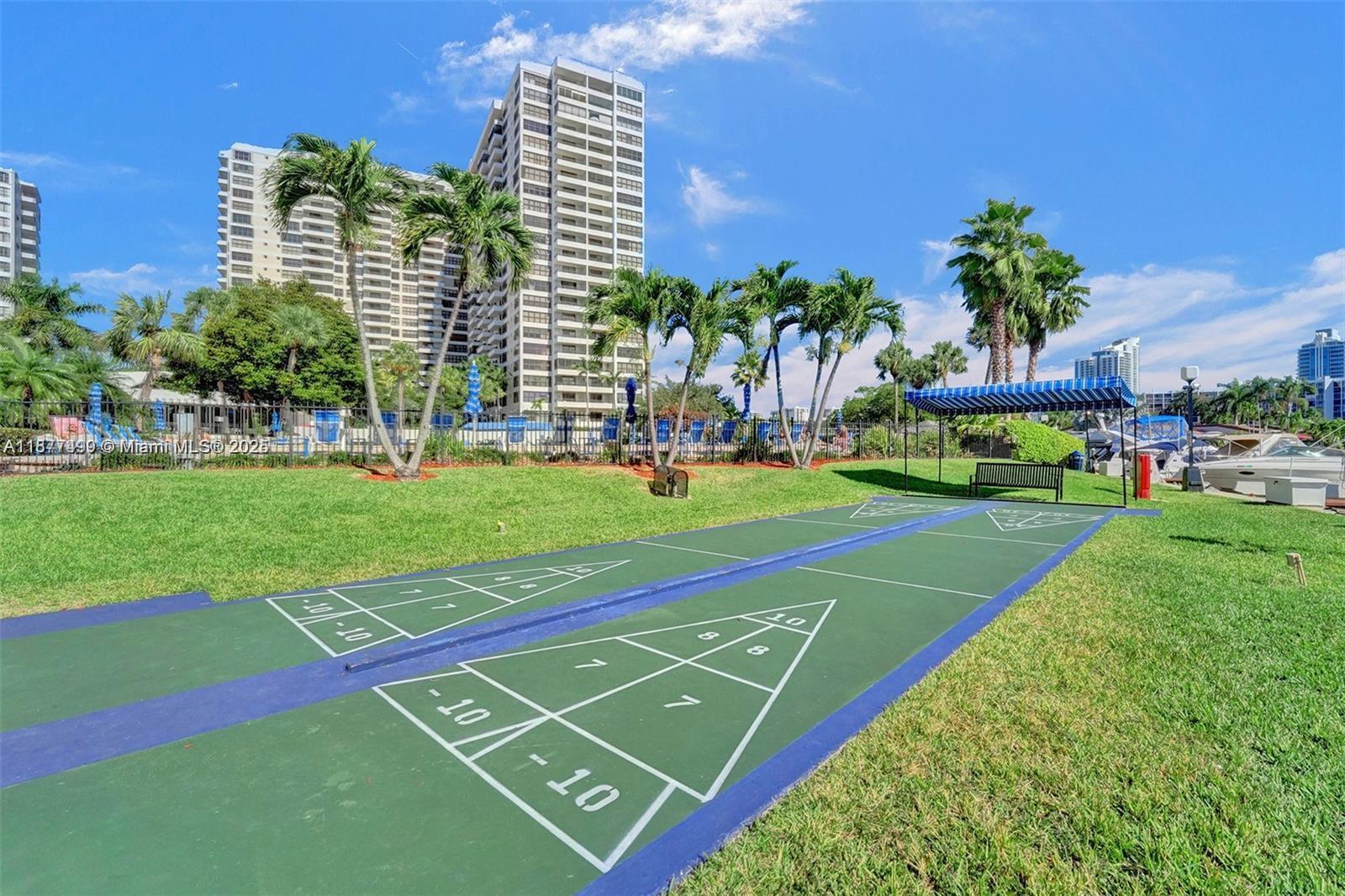 500 Three Islands Boulevard, Unit 320 Hallandale Beach, FL 33009 - Photo 27 of 27 a view of a tennis ground with large trees