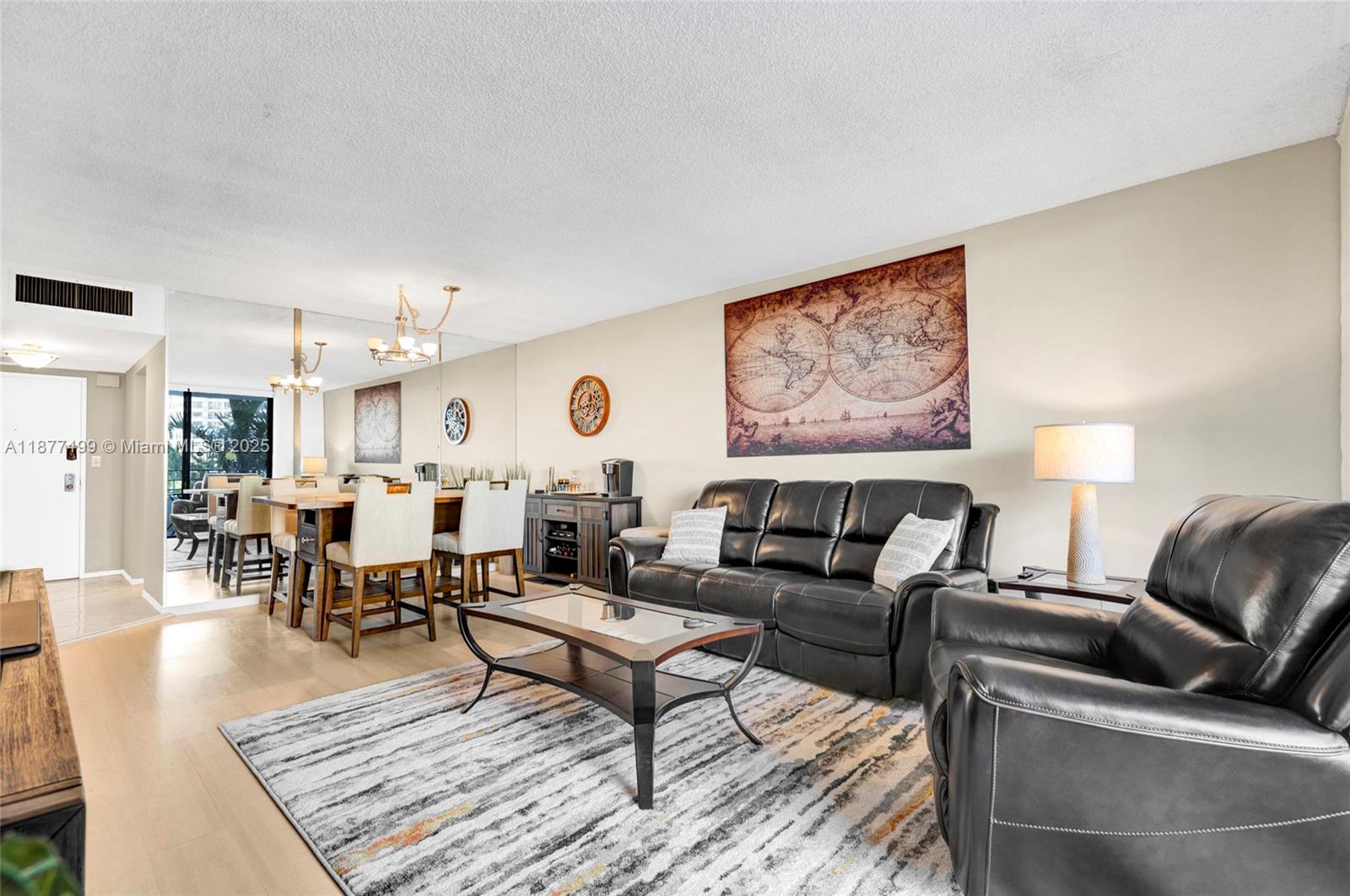 500 Three Islands Boulevard, Unit 320 Hallandale Beach, FL 33009 - Photo 4 of 27 a living room with furniture and wooden floor