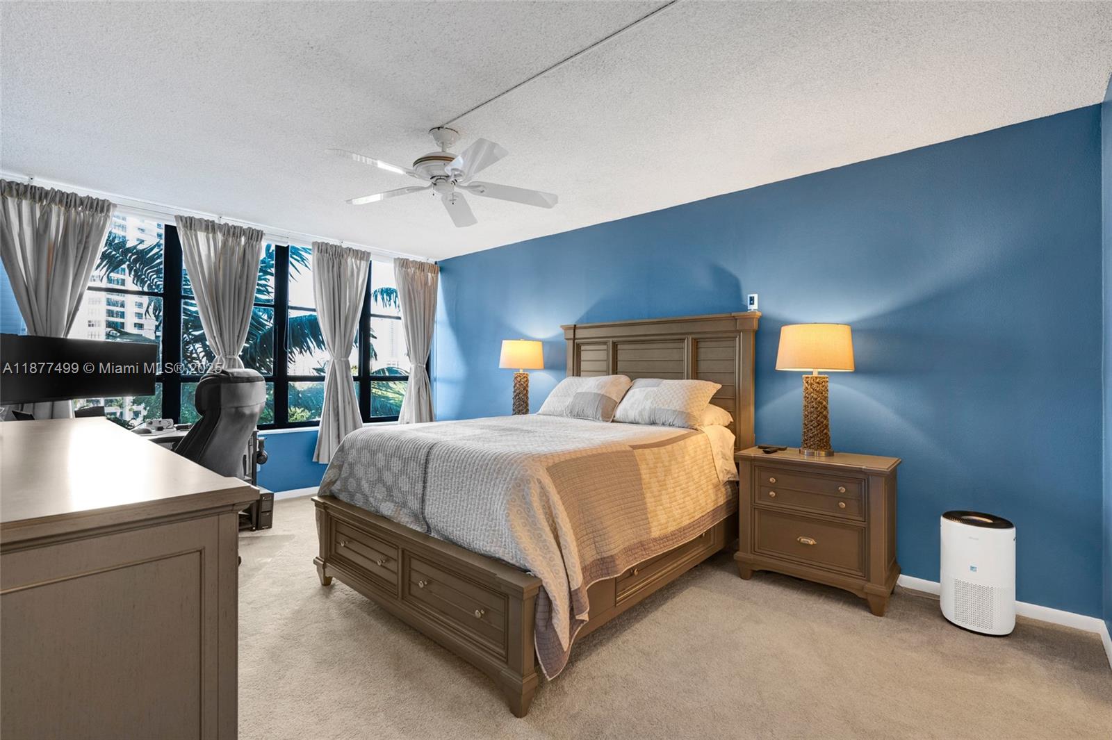 500 Three Islands Boulevard, Unit 320 Hallandale Beach, FL 33009 - Photo 7 of 27 a bedroom with a bed and a night stand