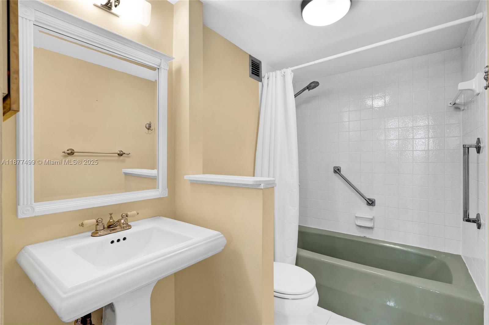 500 Three Islands Boulevard, Unit 320 Hallandale Beach, FL 33009 - Photo 10 of 27 a bathroom with a sink a toilet and a bathtub