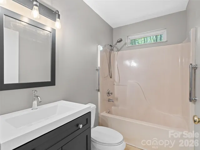 a view of empty room with wooden walls