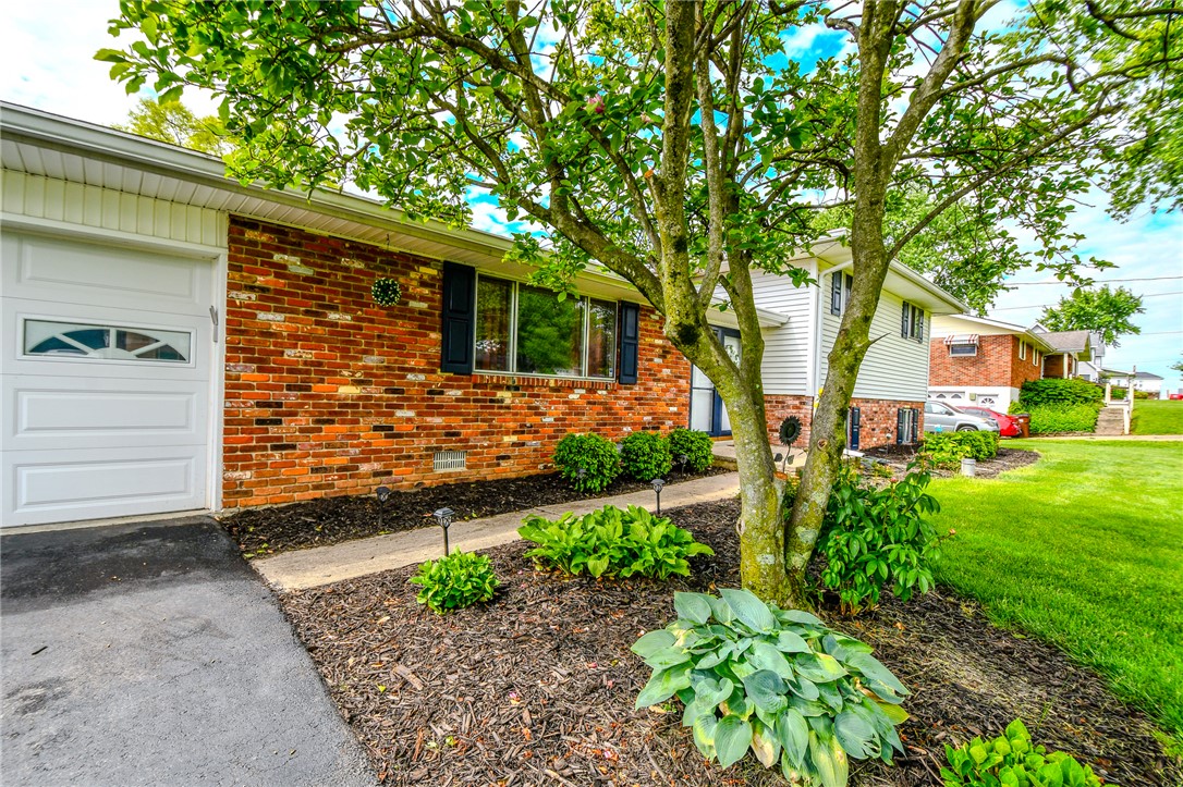 10833 Kendig Road Medway, OH 45341 - Photo 5 of 46 This charming residence features a classic brick and siding exterior with an inviting front yard.