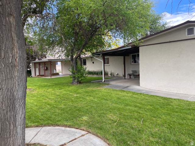 438 East Main Street Elsinore, UT 84724 - Photo 6 of 43 Expansive lawn area with mature trees and concrete pathways