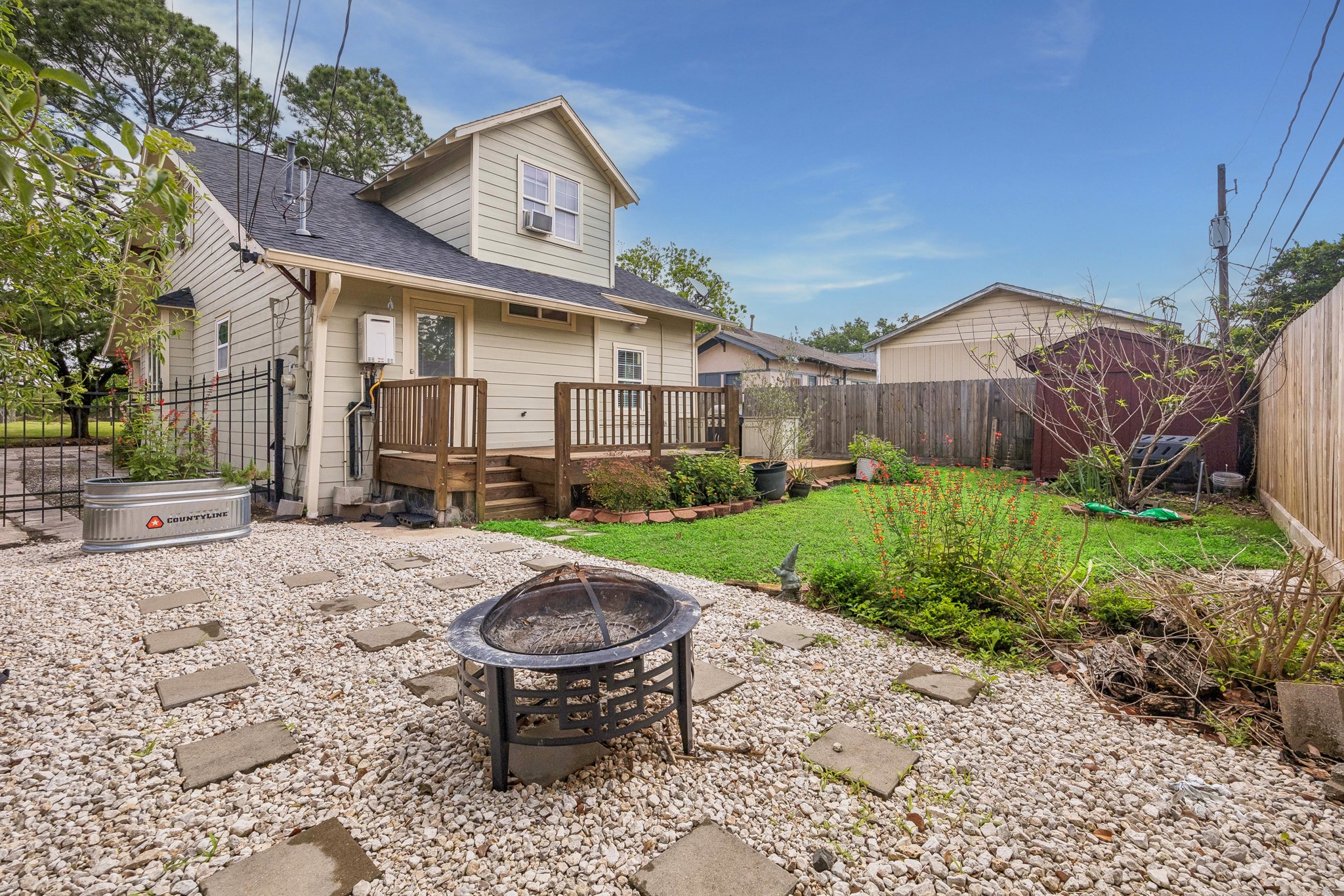 4412 Rusk Street Houston, TX 77023 - Photo 31 of 44 Closer view of expanded patio, flanked by lush green landscaping! Fully-fenced yard is perfect for pets, and the expanded patio makes outdoor entertaining a breeze!