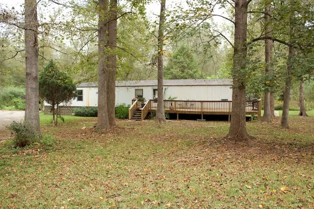 a view of a house with backyard porch and sitting area
