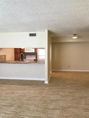 a view of a refrigerator in an empty room