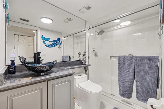 a living room with furniture and a painting on the wall