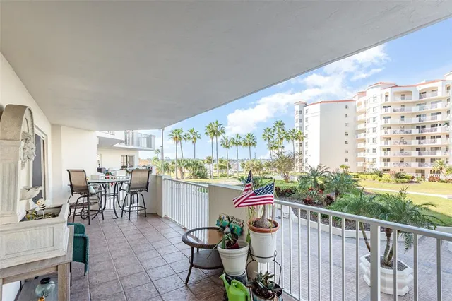 a balcony with furniture and potted plants