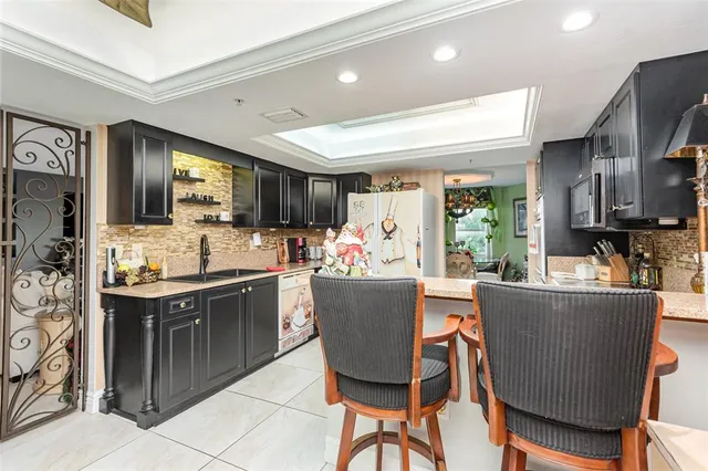 a kitchen with stainless steel appliances a stove a sink and a refrigerator