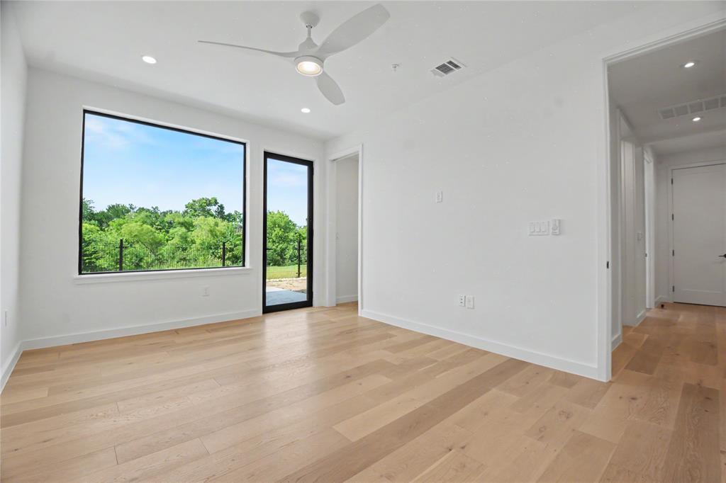 1111 Raiford Road, Unit 104 Carrollton, TX 75007 - Photo 22 of 30 an empty room with wooden floor and a window
