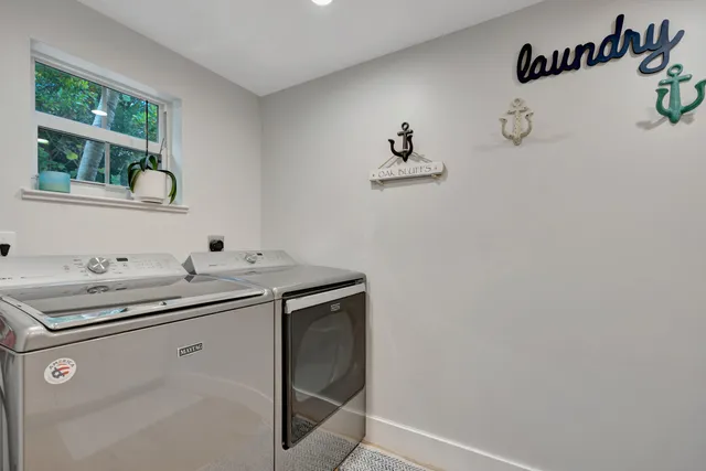 a large kitchen with stainless steel appliances kitchen island granite countertop a sink a counter space and a view of living room