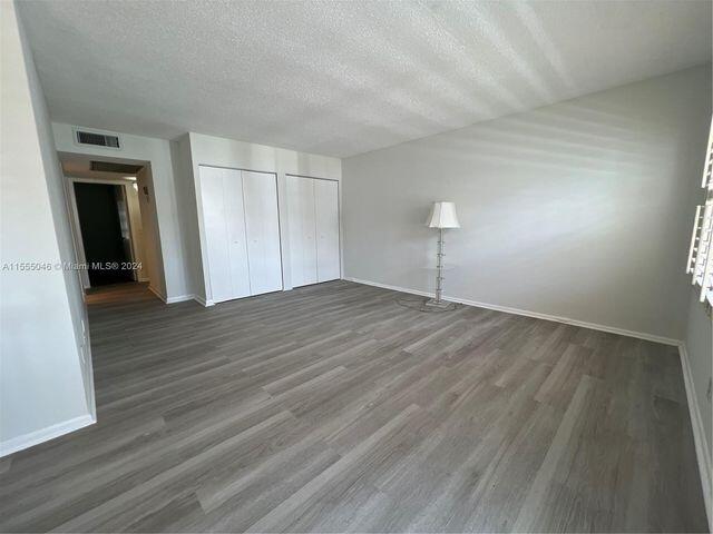 488 Fanshaw L, Unit 488 Boca Raton, FL 33434 - Photo 5 of 10 a view of empty room with wooden floor