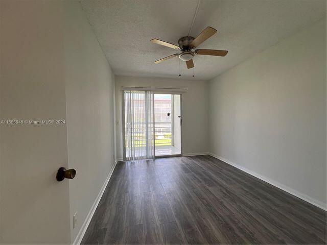 488 Fanshaw L, Unit 488 Boca Raton, FL 33434 - Photo 8 of 10 a view of empty room with wooden floor and fan