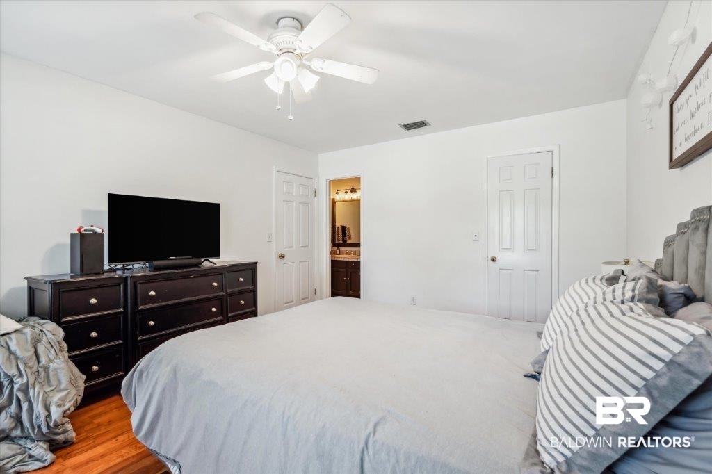 3616 Vista Ridge Drive Mobile, AL 36693 - Photo 11 of 20 Bedroom with hardwood / wood-style floors, ceiling fan, and ensuite bathroom