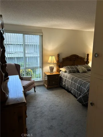 a bedroom with a bed and cabinets
