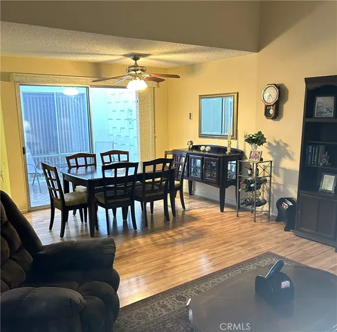 a dining room with furniture window and wooden floor