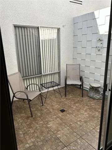 a kitchen with white cabinets and a window
