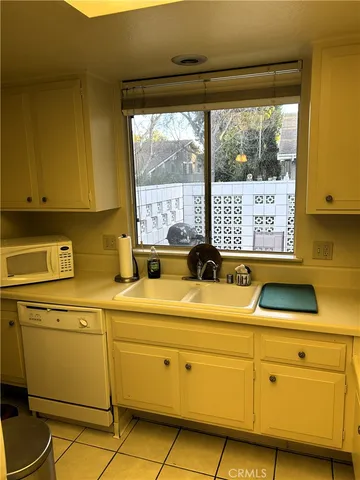 a kitchen with stainless steel appliances granite countertop a sink and a refrigerator