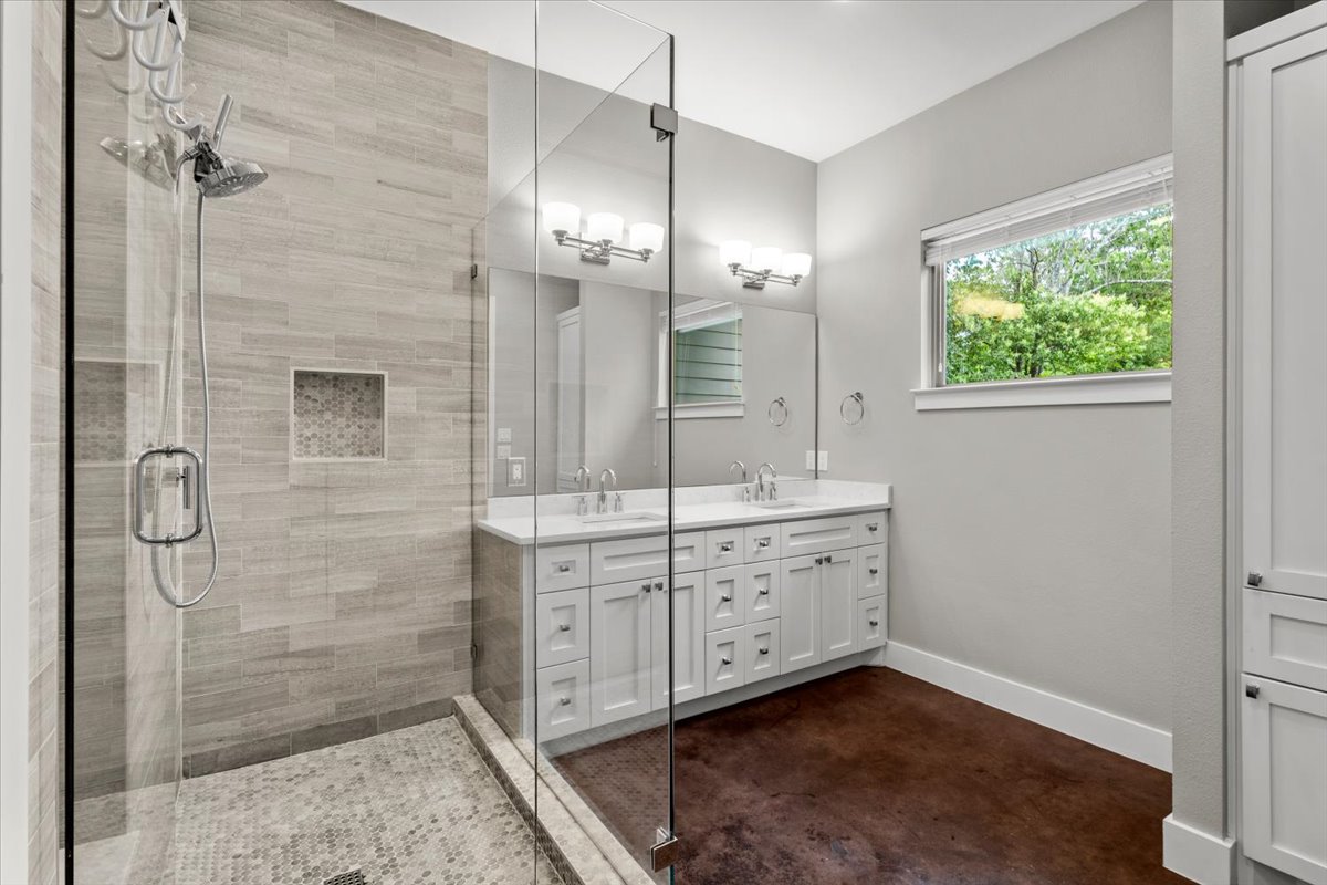 913 Stobaugh Street, Unit B Austin, TX 78757 - Photo 26 of 40 A well-appointed bathroom features a spacious walk-in shower and dual vanities, perfect for morning routines.