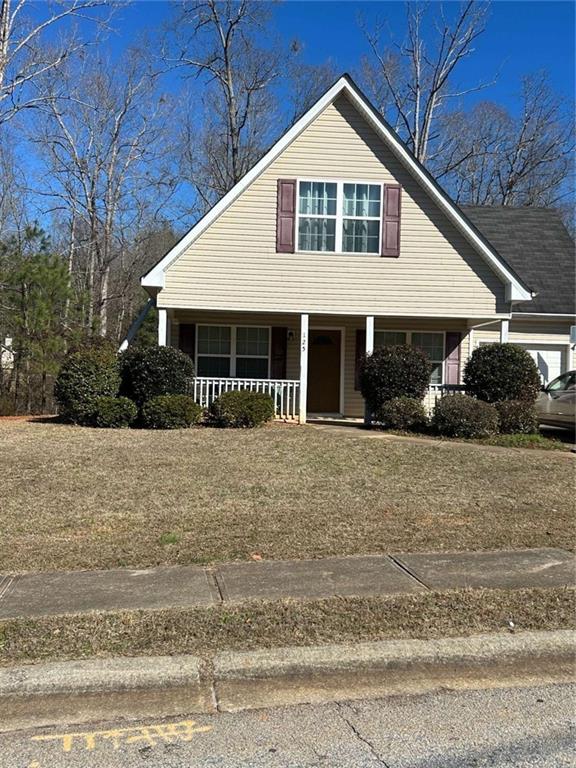 125 Sampson Court Covington, GA 30016 - Photo 1 of 13 a front view of a house with a yard