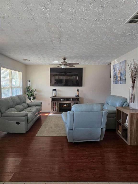 125 Sampson Court Covington, GA 30016 - Photo 2 of 13 a living room with furniture and a flat screen tv