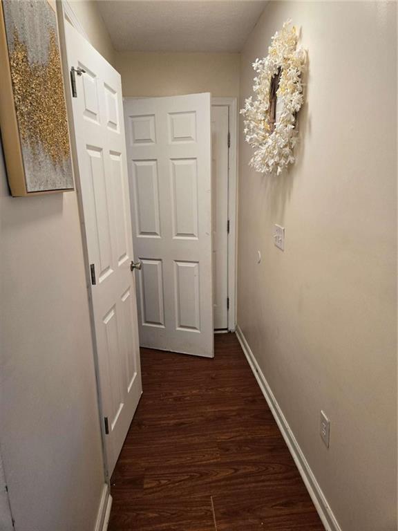 125 Sampson Court Covington, GA 30016 - Photo 5 of 13 a view of a hallway with wooden floor and staircase