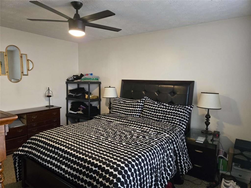 125 Sampson Court Covington, GA 30016 - Photo 6 of 13 a bedroom with a bed and dresser