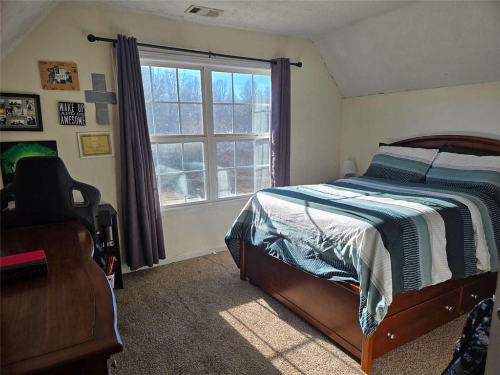 125 Sampson Court Covington, GA 30016 - Photo 8 of 13 a bed sitting in a bedroom next to a window