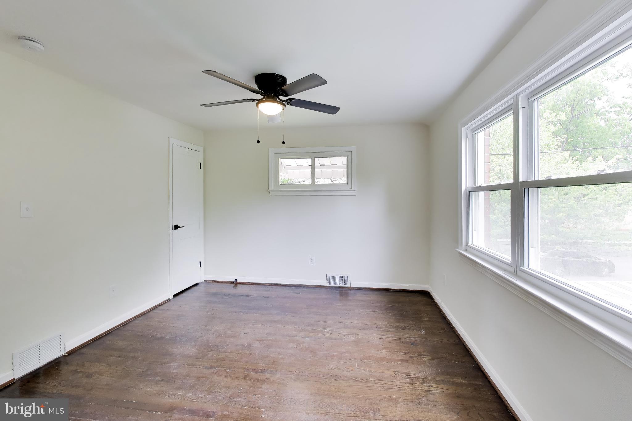 186 Forrester Street Southwest Washington, DC 20032 - Photo 15 of 32 wooden floor in an empty room with a window