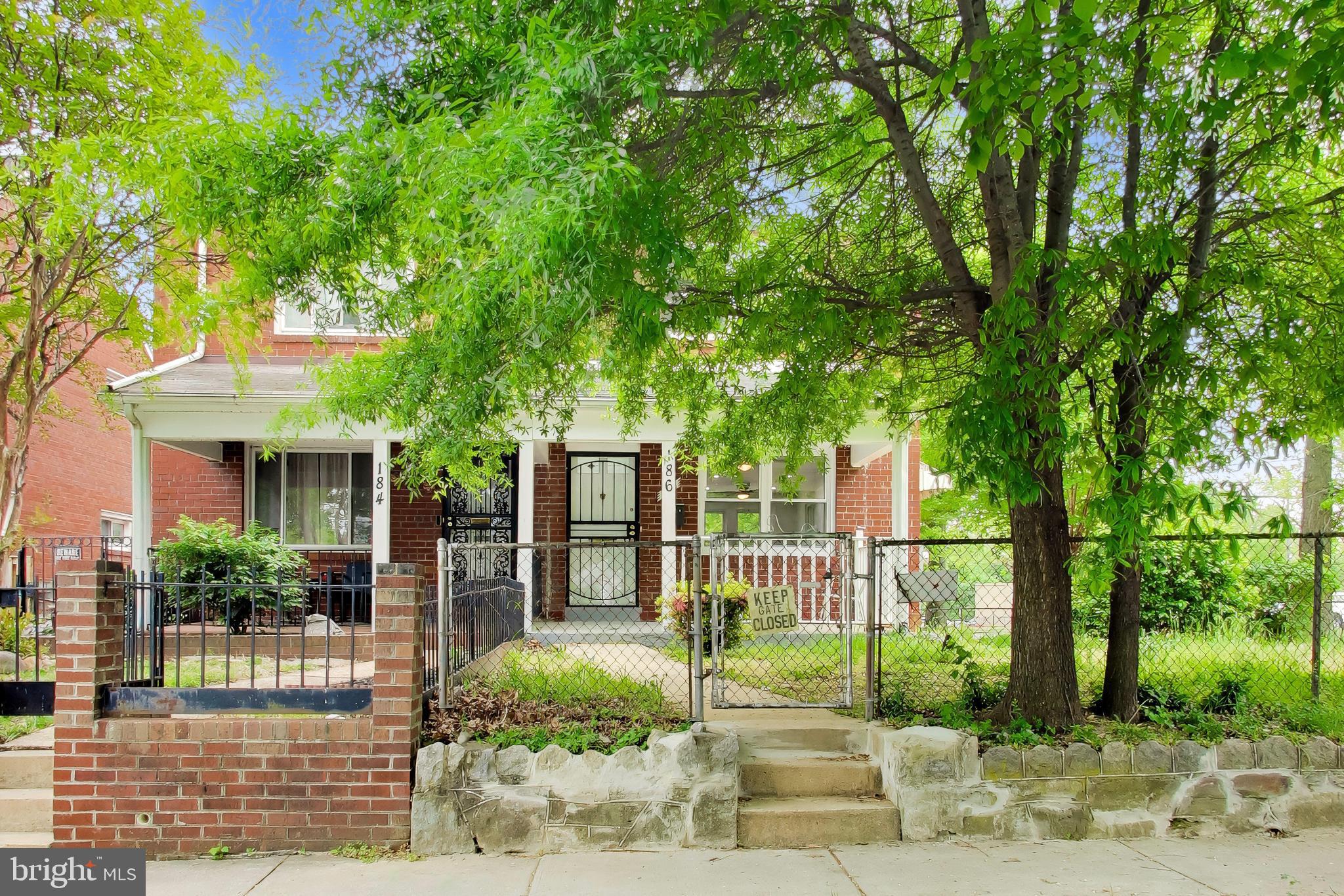 186 Forrester Street Southwest Washington, DC 20032 - Photo 2 of 32 a view of a house with a tree in front