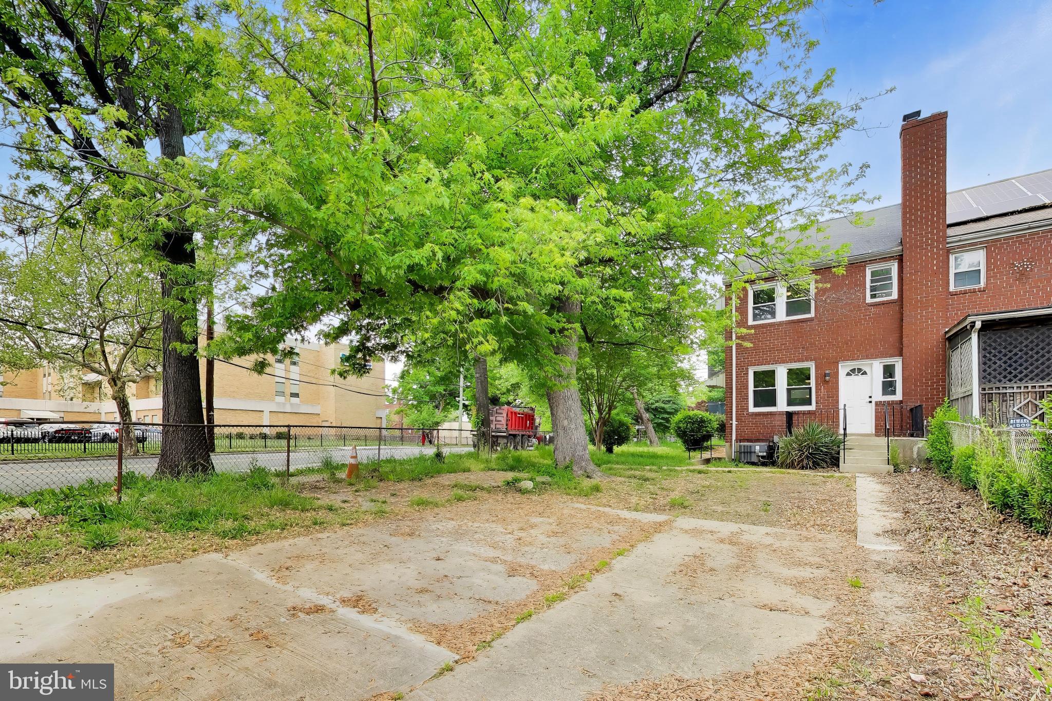 186 Forrester Street Southwest Washington, DC 20032 - Photo 28 of 32 a view of a house with a yard and large tree