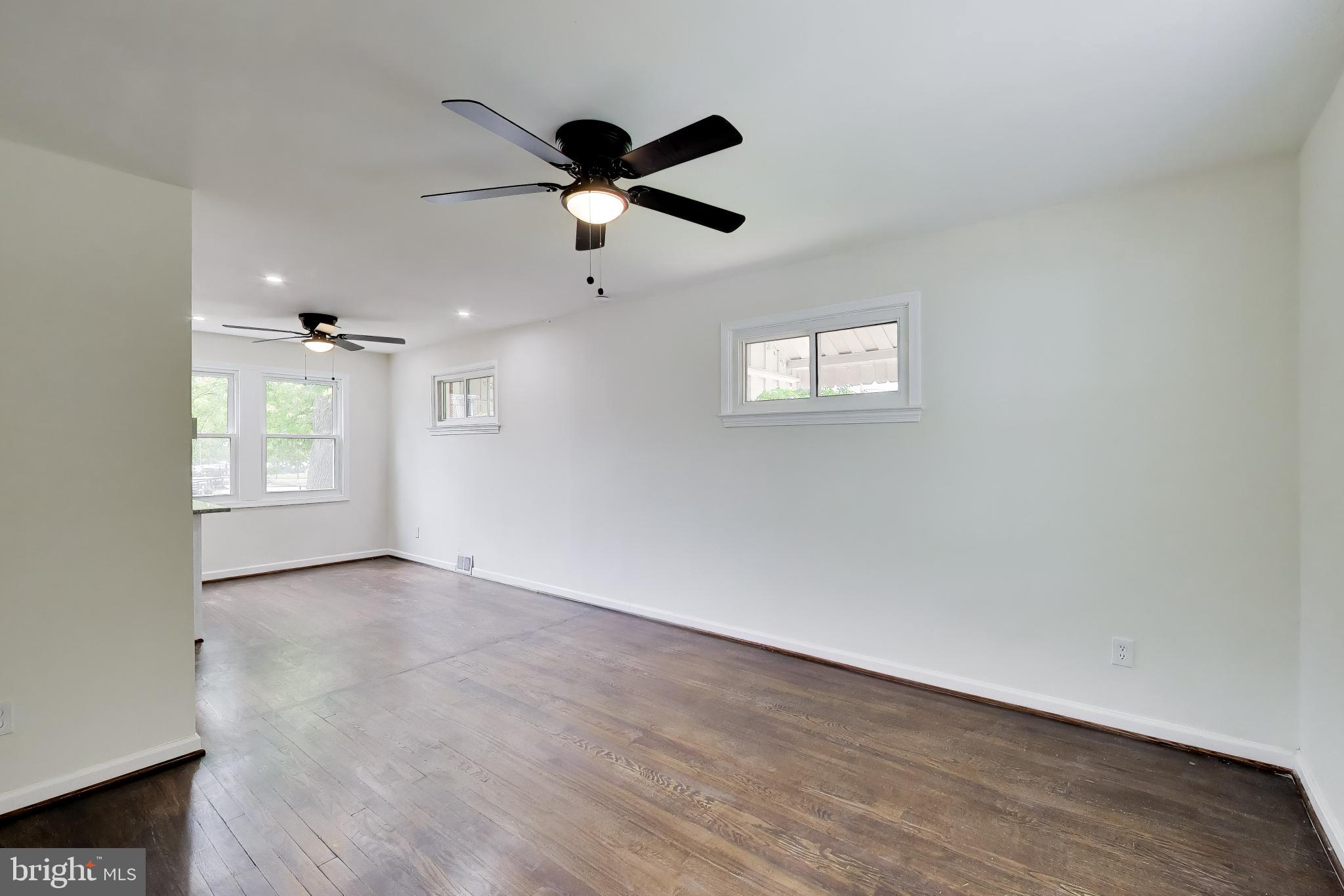 186 Forrester Street Southwest Washington, DC 20032 - Photo 6 of 32 wooden floor in an empty room with a window