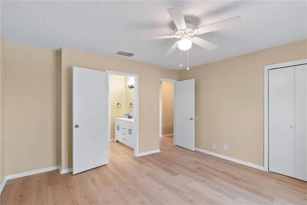 a bedroom with a large bed and a window